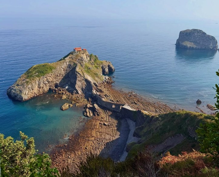 San Juan de Gaztelugatxe from the coast path with the Aketx sea stack beyond
